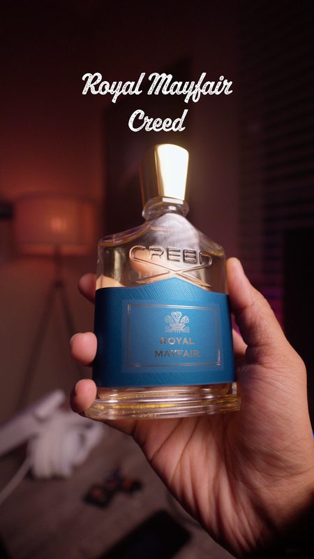 Creed Royal Mayfair bottle held in hand in a softly lit room — cinematic fragrance photography, Bay Area